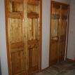 Pine stain and urethane finished heavy construction raised panel bi-fold doors.